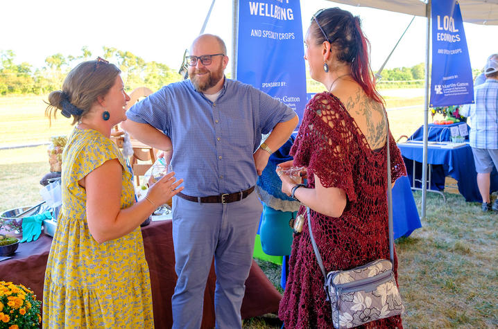 Co-director Brett Wolff welcoming two women at the 25-year anniversary event at South Farm