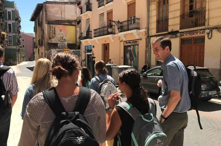 UK Deputy General Counsel Cliff Iler walks with Education Abroad students in city in Spain