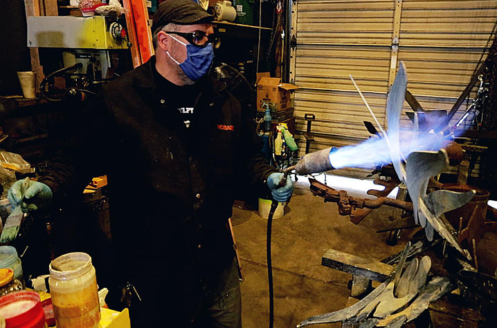 photo of Jeremy Colbert working on sculpture