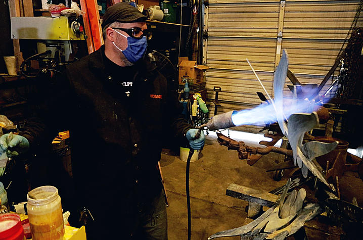 photo of Jeremy Colbert using a torch to make a sculpture