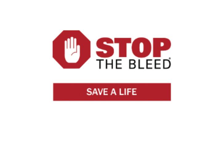 Stop the Bleed logo featuring a red stop-sign hand symbol next to the words “STOP THE BLEED” in red and black text above a red banner reading “SAVE A LIFE.”