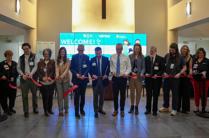 Image of hospital administrators cutting a ribbon