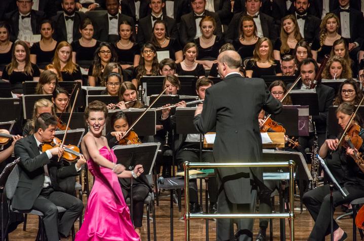 photo of vocalist performing before UK orchestra and choirs at Bernstein concert