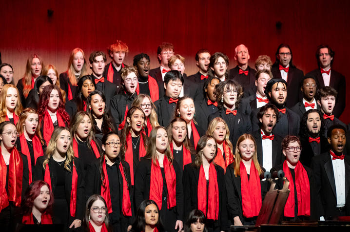 Chorus members performing on stage