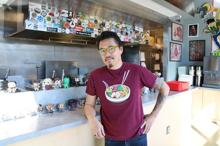 photo of Dan Wu in front of his kitchen at Atomic Ramen in The Barn at The Summit