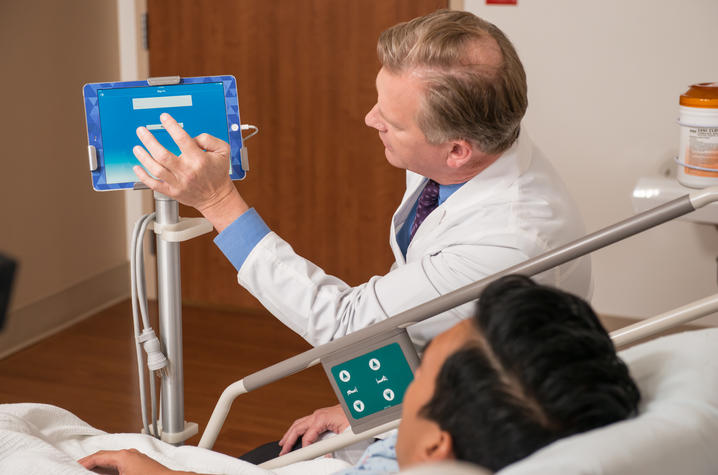 A doctor uses the VRI unit to communication with a patient