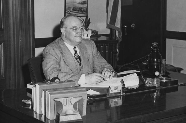 black and white photo of Governor Earle C. Clements seated at desk