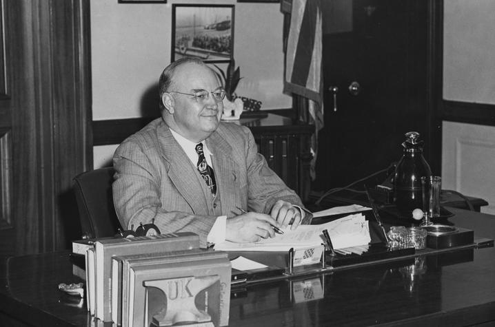 black and white photo of Governor Earle C. Clements seated at desk