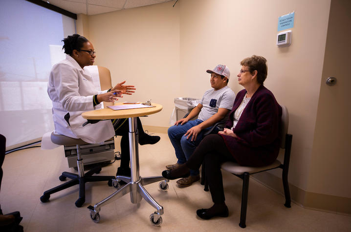 Photo of Dr. Ima Ebong with patient Zack Price and his mother Nina