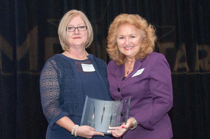 Two women holding award