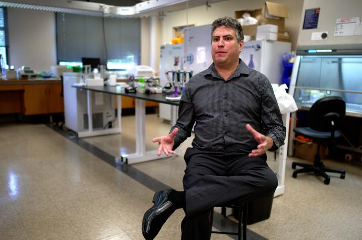 Scott Berry sitting on a chair in his laboratory