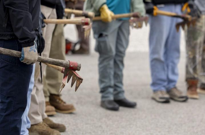 photo of students holding different tools Students standing while holding different tools used in forest fire fighting