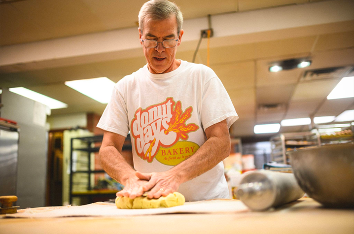 As the owner of Donut Days Bakery, Fred Wohlstein spends his days surrounded by delicious—and tempting—baked goods. (Photo was taken before COVID-19)