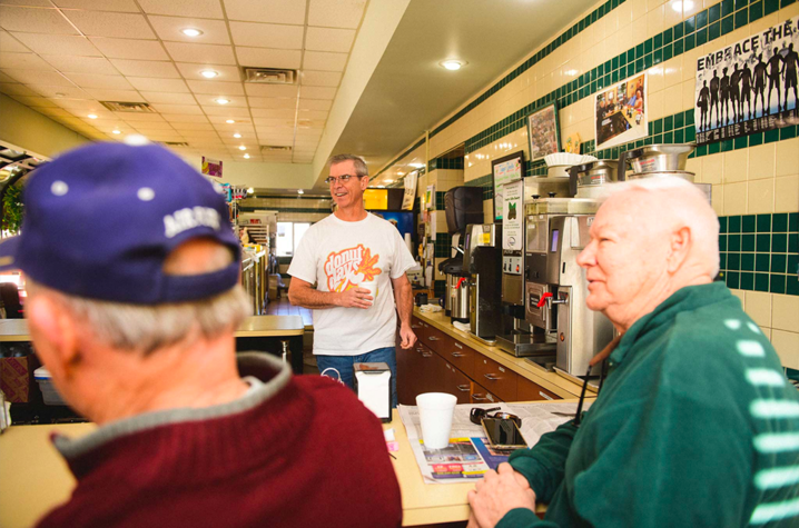 Fred Wohlstein talking with his customers inside Donut Days Bakery. (photo was taken prior to COVID-19)