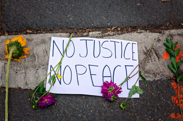 photo of protest sign "No Justice No Peace"