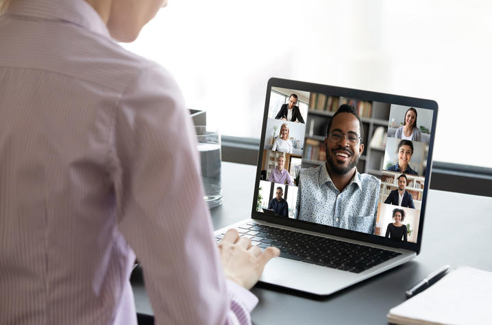 woman viewing a Zoom meeting on her laptop.