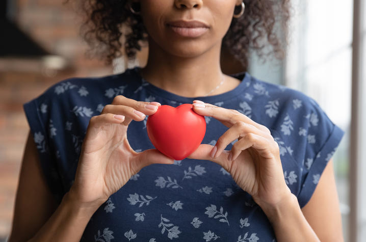 image of woman holding red heart
