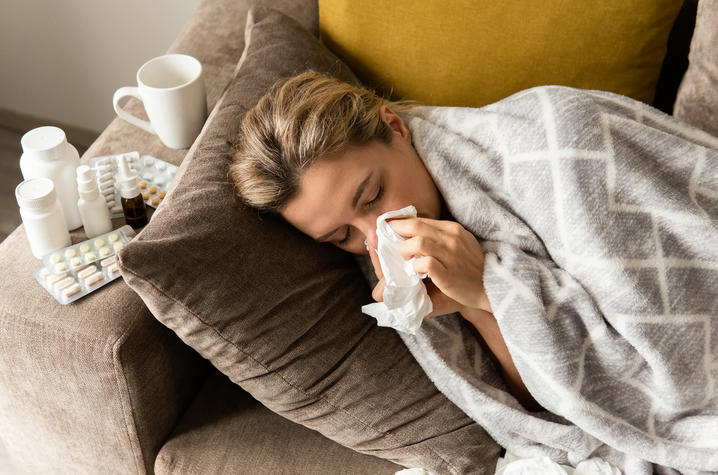 A woman blows her nose