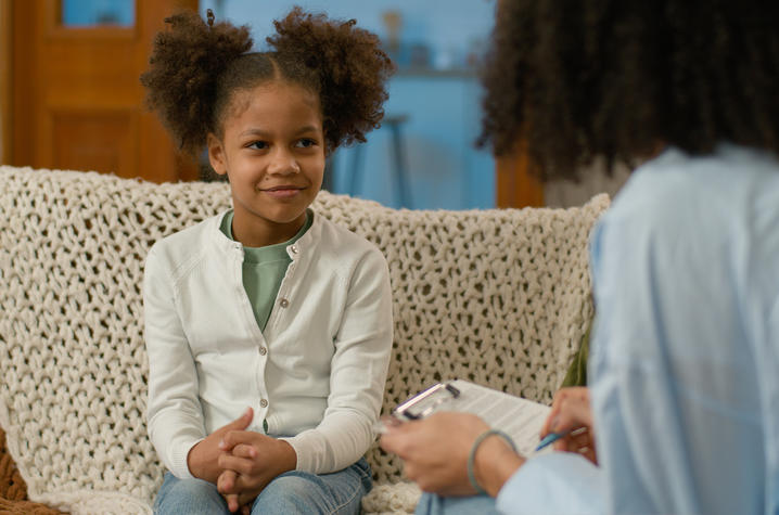 image of young african-american girl speaking with a mental health provider