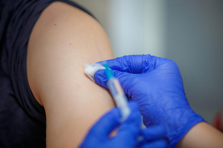 photo of person receiving a flu shot in the arm