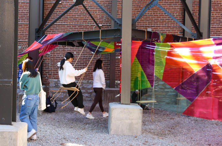 Knitted pillows and swinging elements invite viewers to pause, reflect and engage with the installation’s immersive atmosphere. Photo by Haley Simpkins. 