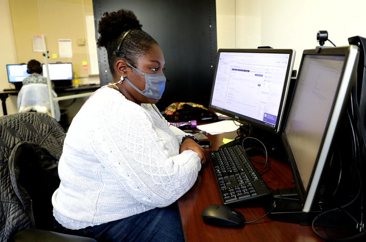 UK Health Corps contact tracer Maya Cleveland at desk