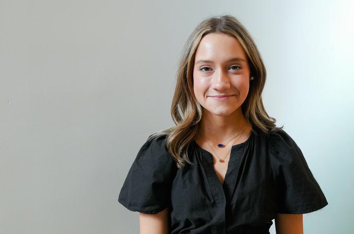 University of Kentucky public health student Hollie Hagan wearing a black dress against a light background.