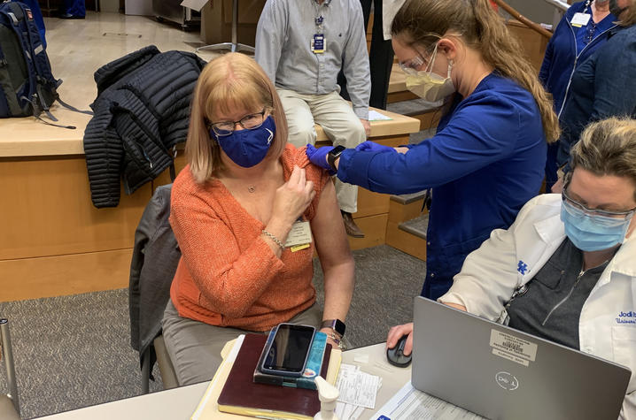 Image of Lynn Kelso receiving the COVID vaccine. 