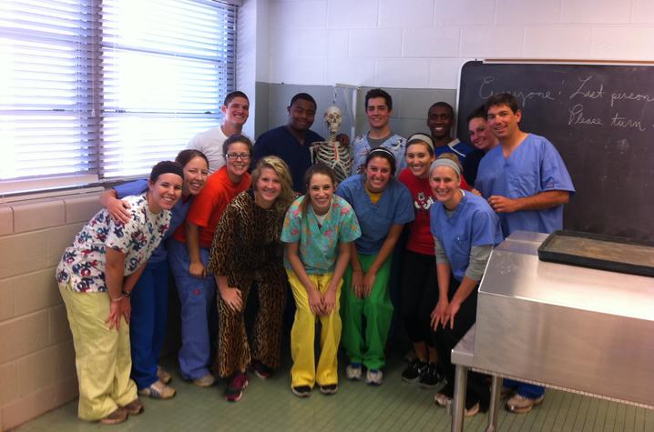 This is a photo of Carl Mattacola with students in the College of Health Sciences.