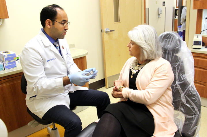 Dr. Musbah explains function of oral appliance to patient Linda Pike