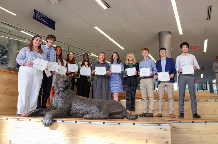 People standing with awards. 
