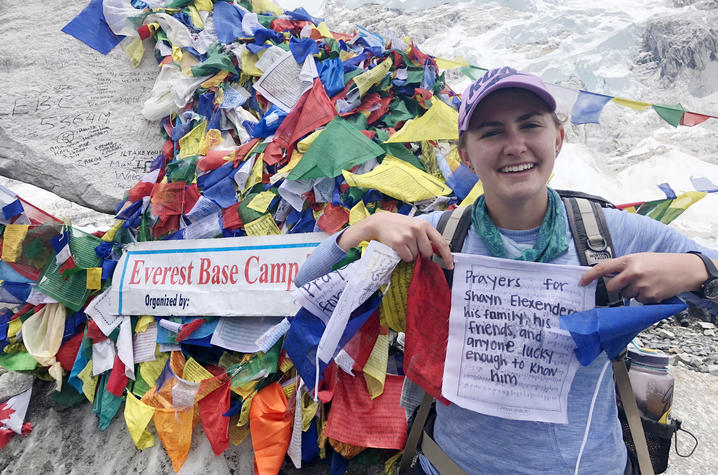 Maya Husayni with prayer flags at Mt. Everest Base Camp