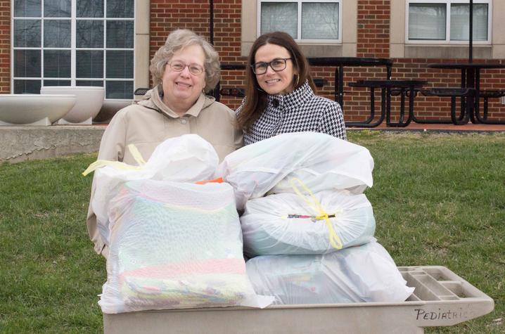 Chapter leader Rosemary Campbell presents 84 quilts and a number of other items to UK HealthCare's Lori Donelson.