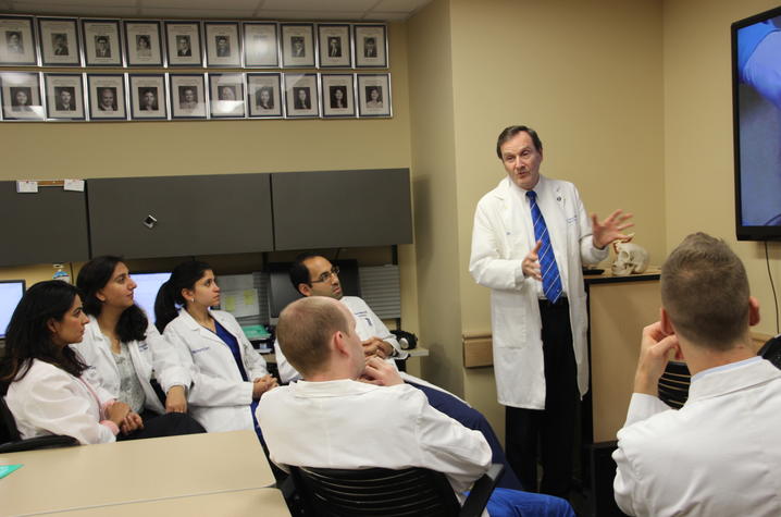 Dr. Okeson working with a group of clinic residents | Photo courtesy UK Dentistry