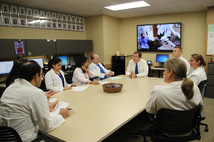 residents meeting with clinic faculty in the current clinic location to discuss patient cases