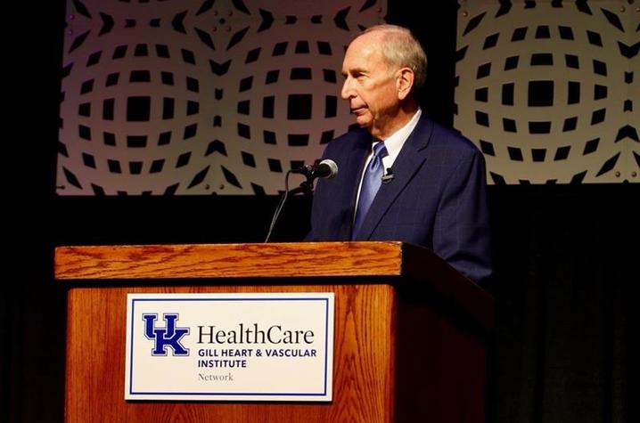 Mark Birdwhistell, UK's senior vice president for health and public policy, speaks at a podium 