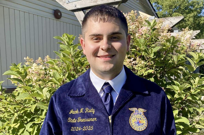 Person posing for picture wearing Future Farmers of America jacket.