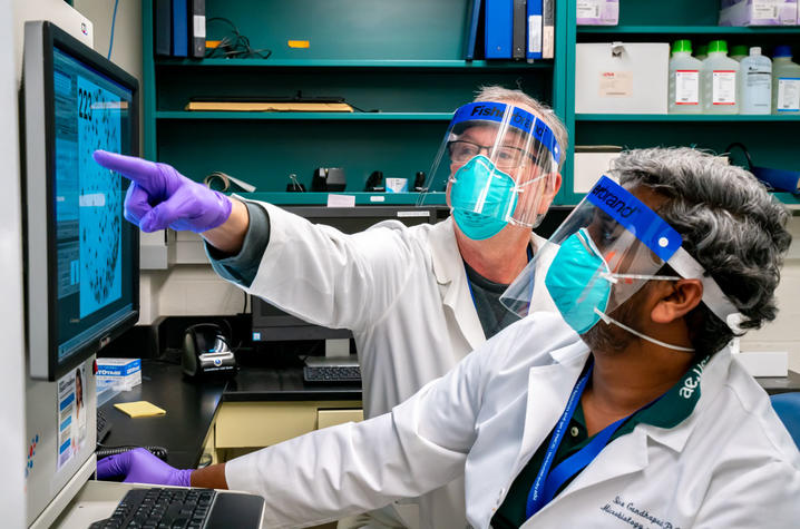 UK researchers Jerry Woodward and Siva Gandhapudi analyzing blood samples in FCIM's immune monitoring lab. Photo by Ben Corwin, Research Communications.