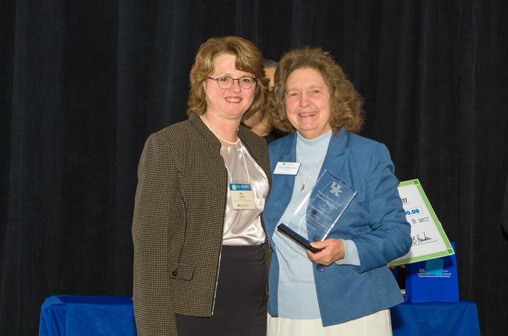 Kim Henken, left, presents award to Judy Hetterman