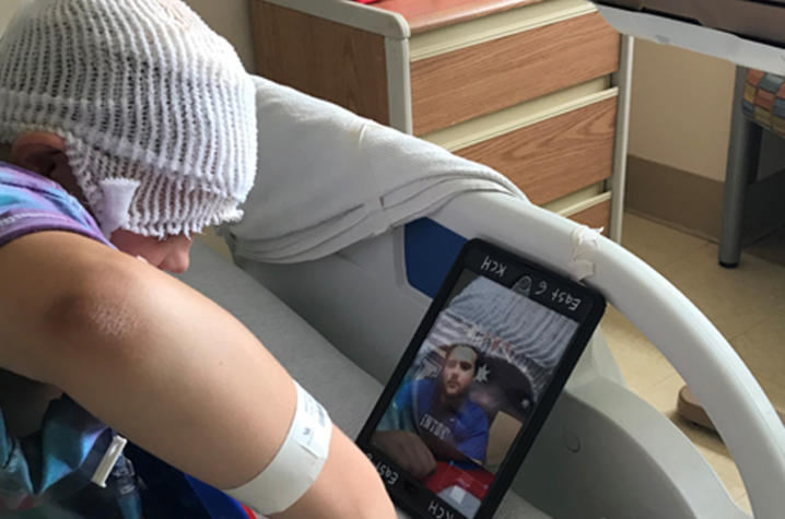 Patient chatting with football player Luke Fortner on ipad
