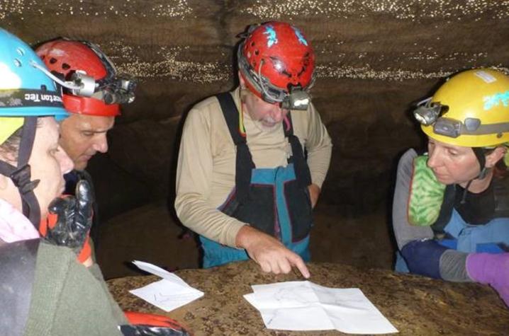 Kentucky Speleological Survey members, including President Howard Kalnitz, center, check their maps during a caving trip.