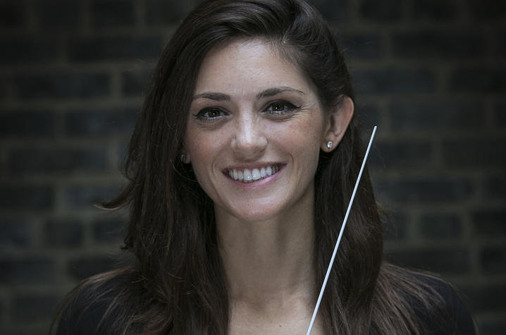 headshot photo of Kaitlin Bove with conducting baton