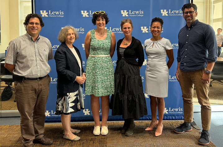 Six professors standing in front of a blue background with UK logos