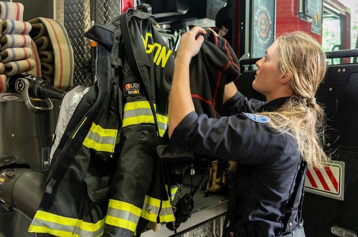 Lexington firefighter putting on gear. 