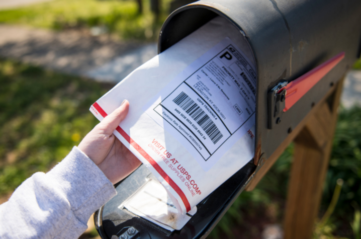 USPS package being pulled out of a mailbox