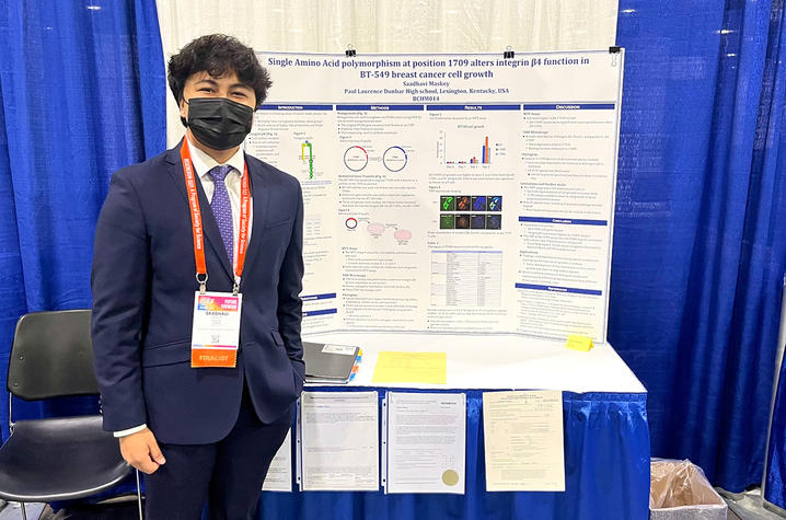 saadhavi maskey standing next to his winning science fair project