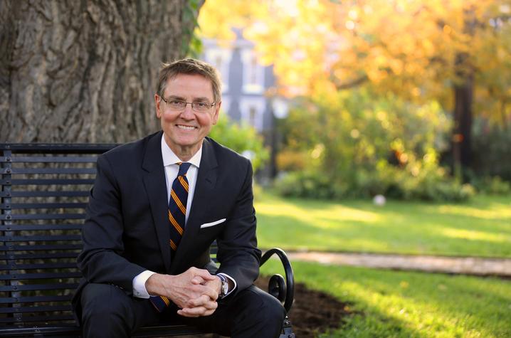 photo of Jim Gray seated on bench