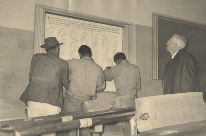 Professor Horine observes as employees hang the handwritten lists | UK Special Collections This is a photo of Professor Horine observing as employees hang the handwritten lists | UK Special Collections