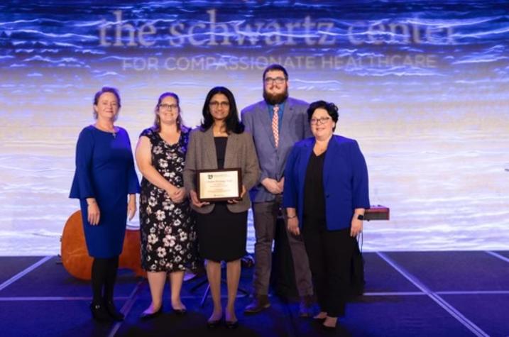 Members of the Complex Discharge Team accept an award