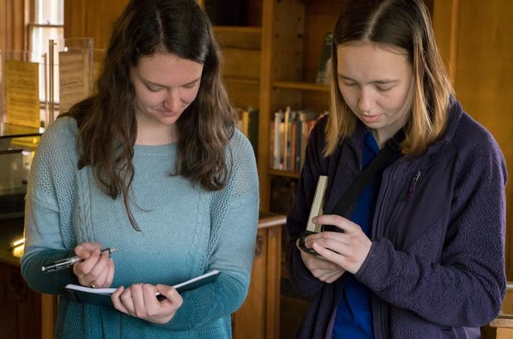 photo of Ali Bertelsman and Hannah Hatch taking notes